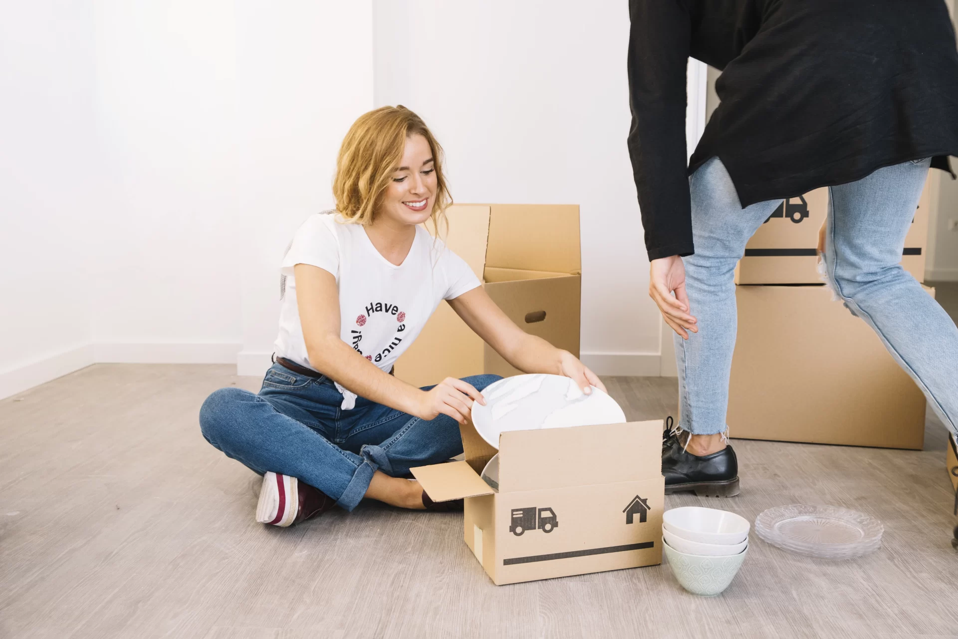 woman with man packing boxes for safe moving with dishes