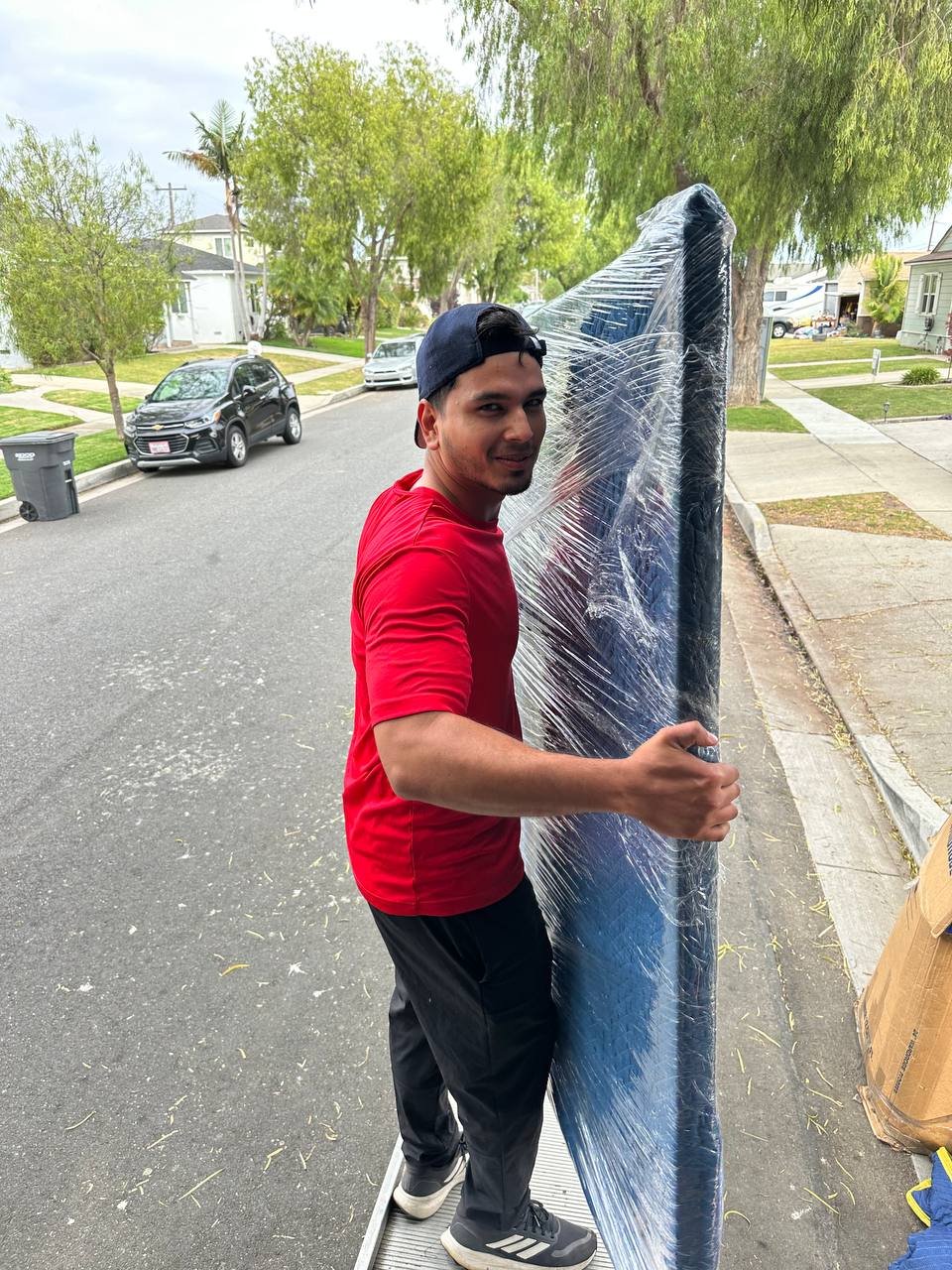 Mover carrying a securely wrapped mattress