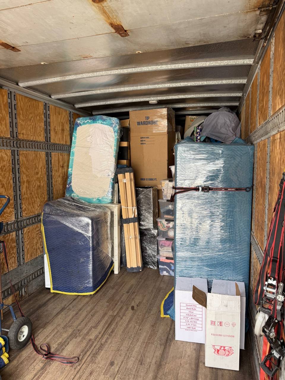 Moving truck loaded with wrapped furniture and boxes for safe transport